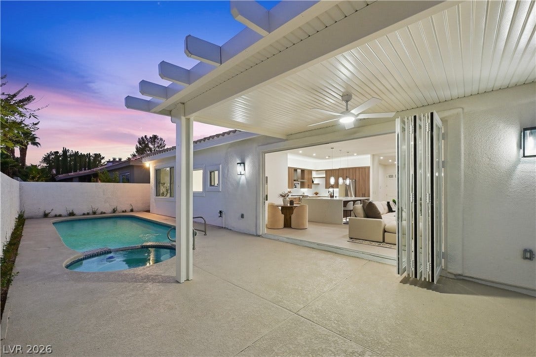 1612 Hidden Spring Drive, Las Vegas, NV 89117 Seamless indoor-outdoor living flows effortlessly from the covered patio to the sparkling pool.