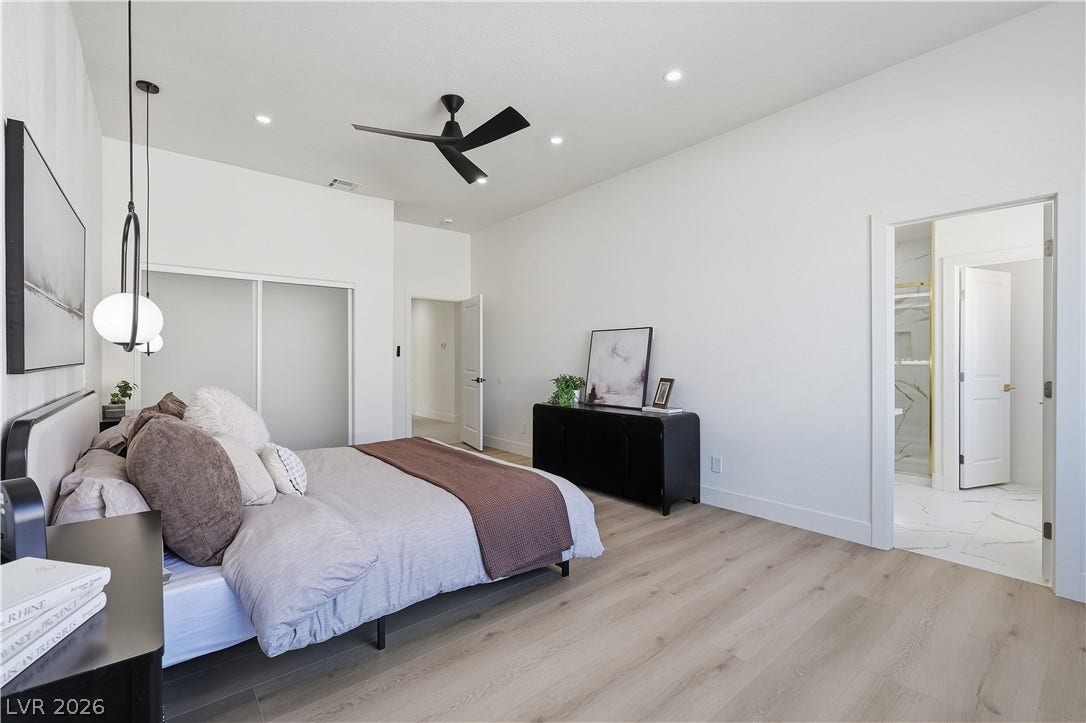 1612 Hidden Spring Drive, Las Vegas, NV 89117 Smooth wood floors and tall ceilings anchor this quiet bedroom suite.