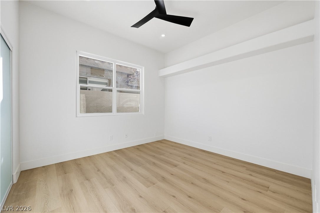 1612 Hidden Spring Drive, Las Vegas, NV 89117 Clean lines and light wood flooring define this versatile bedroom space.