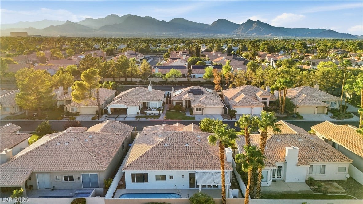 1612 Hidden Spring Drive, Las Vegas, NV 89117 Panoramic neighborhood views extend past manicured properties to towering mountain silhouettes on the horizon.