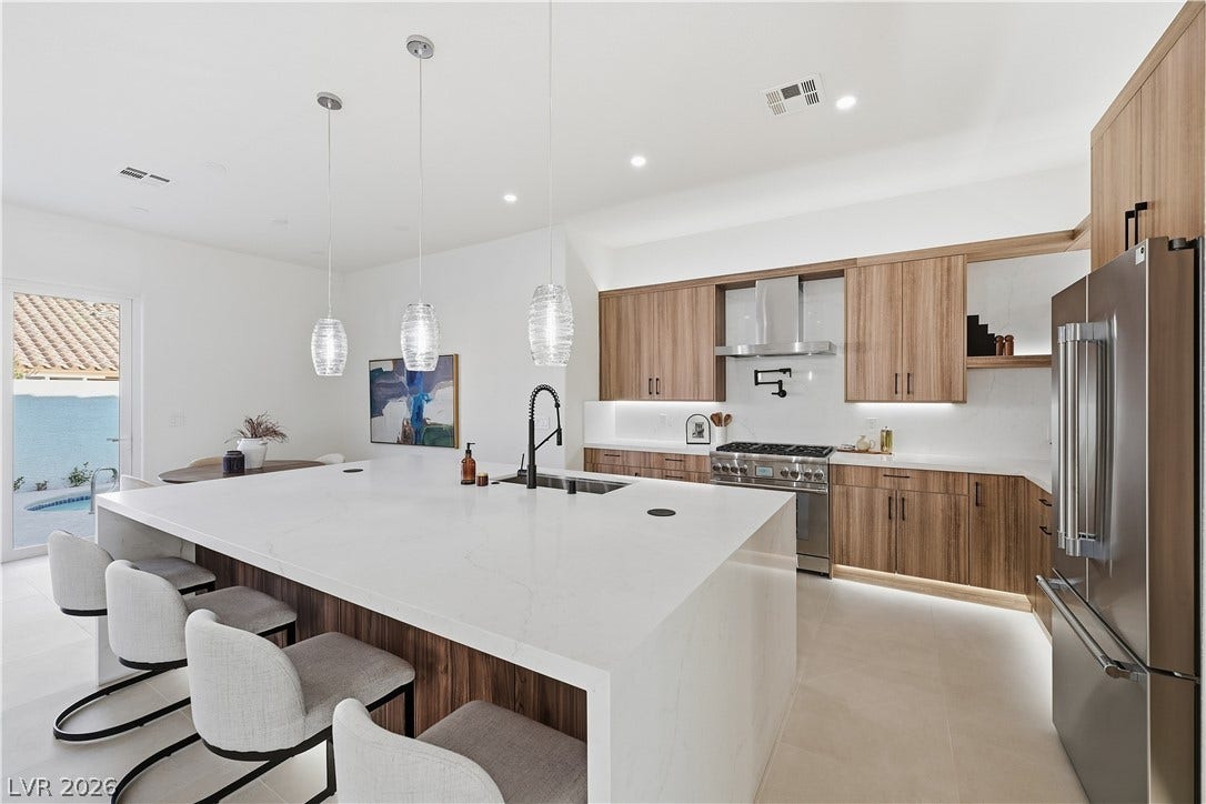 1612 Hidden Spring Drive, Las Vegas, NV 89117 Gleaming stone countertops and warm wood cabinetry define this contemporary culinary space.