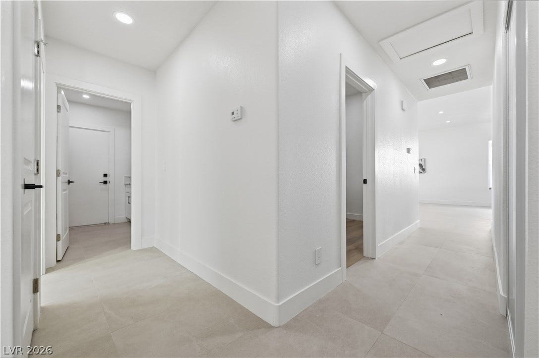 1612 Hidden Spring Drive, Las Vegas, NV 89117 Recessed lighting illuminates this crisp hallway showcasing clean lines and durable tile flooring.