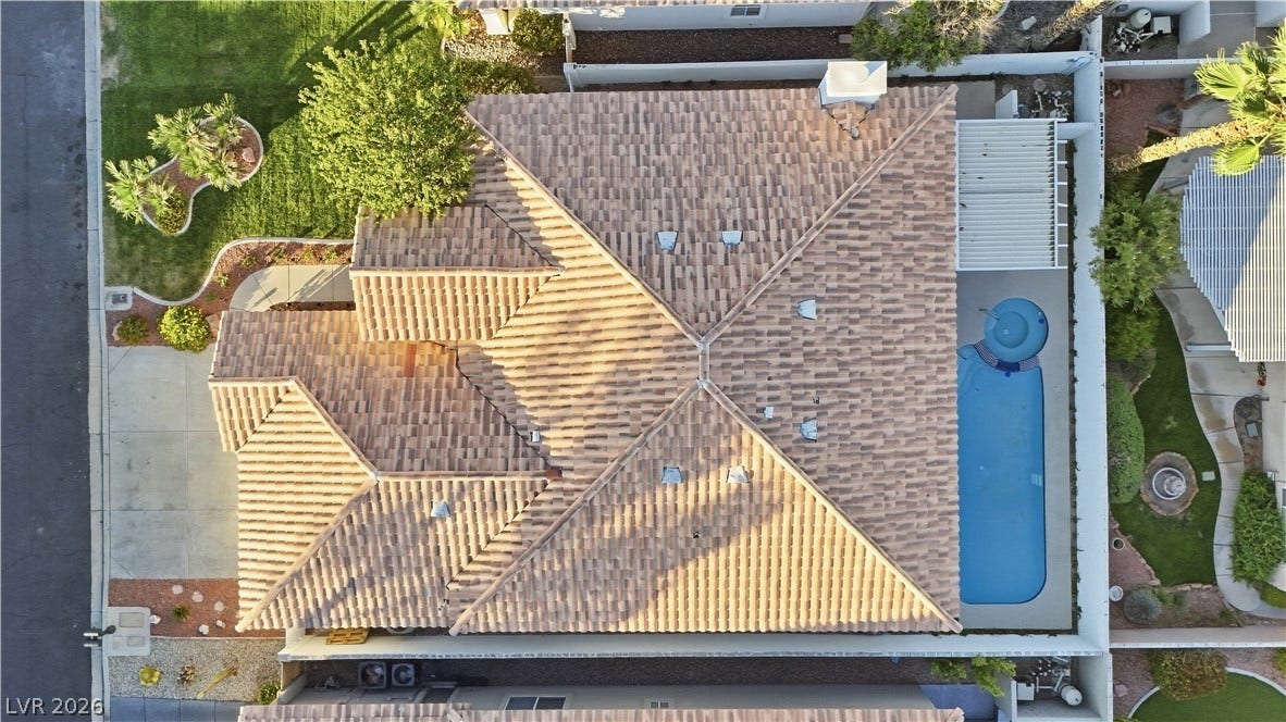 1612 Hidden Spring Drive, Las Vegas, NV 89117 An aerial perspective reveals the clay tile roof and a private swimming pool in the backyard.