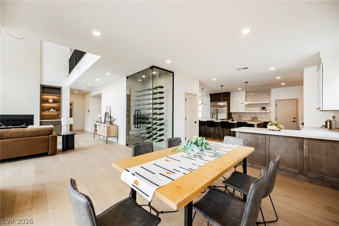 Hardwood floors and an integrated glass wine display anchor this open-concept main level floorplan.