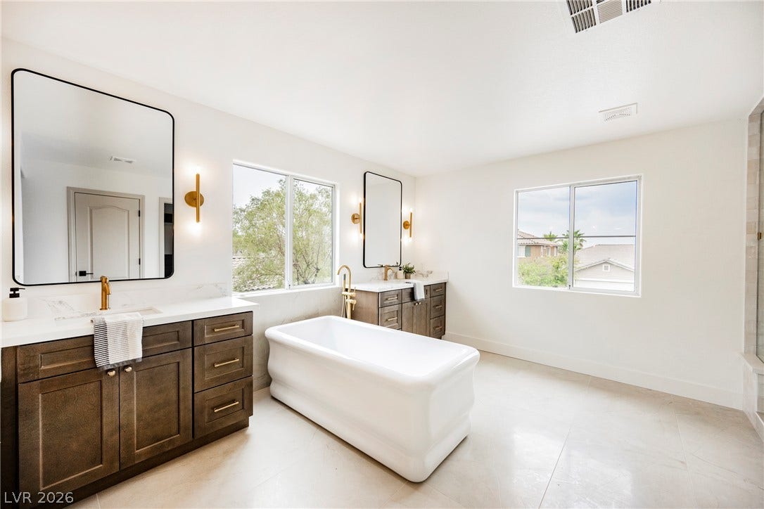 Clean lines and a freestanding tub define this airy, light-filled washroom.