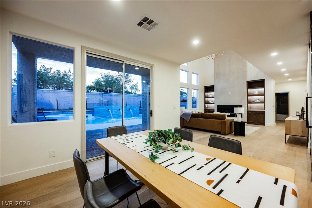 A spacious dining area features sliding glass doors that open to the backyard pool.