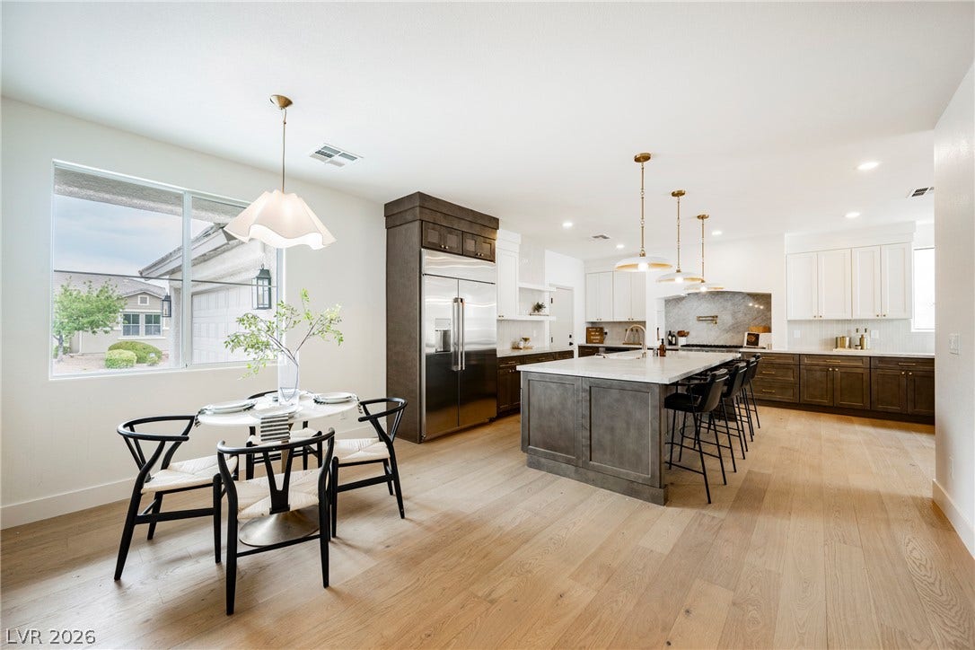 An open floorplan seamlessly connects the casual dining area to a modern kitchen.
