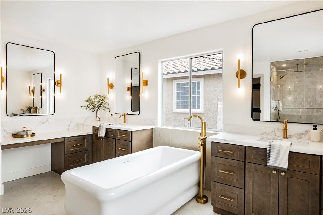 Clean lines and a freestanding tub define this elegantly appointed master bathroom.