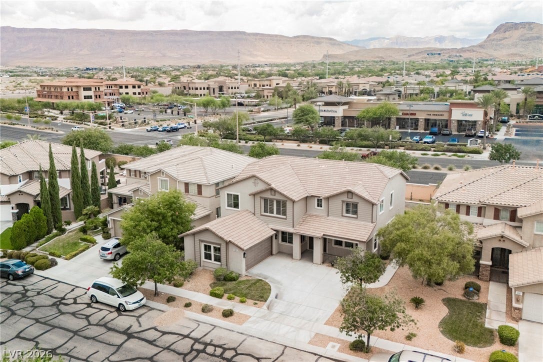 Nestled in a peaceful neighborhood, this home showcases tile roofs and a concrete driveway.