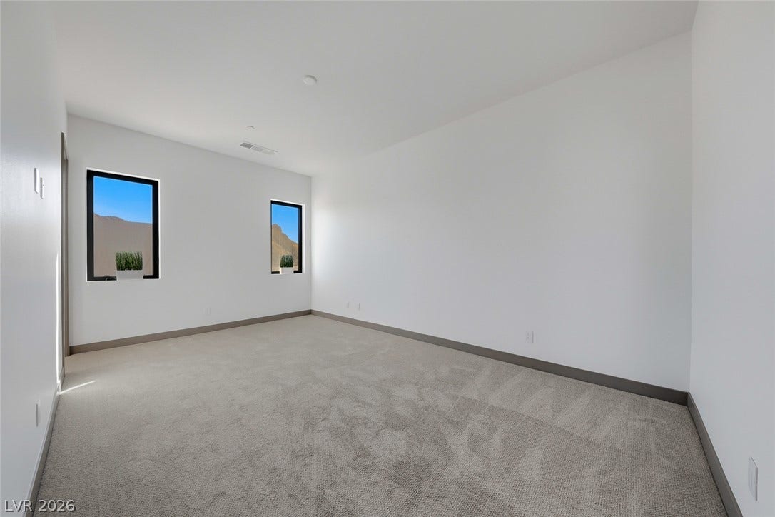 30 Sand Star Lane, Henderson, NV 89011 Crisp walls and plush carpeting define this versatile interior space with desert views.
