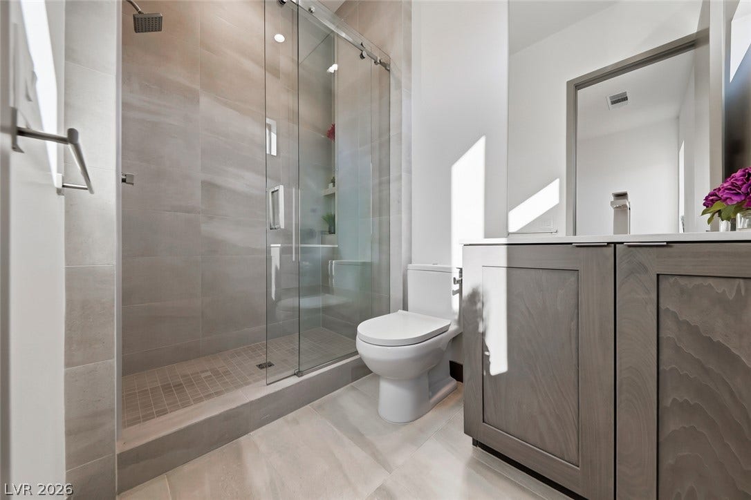 30 Sand Star Lane, Henderson, NV 89011 Clean lines and a spacious tile shower define this modern bathroom space.