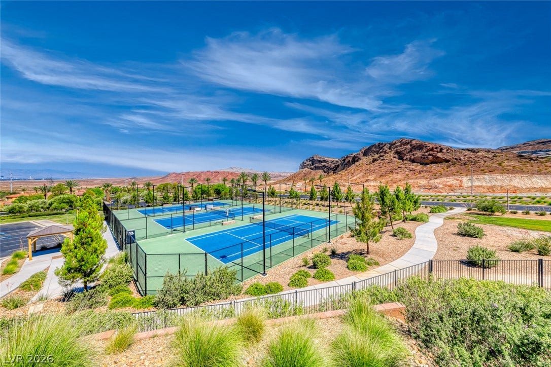 30 Sand Star Lane, Henderson, NV 89011 Professional-grade outdoor tennis courts sit set against a dramatic desert mountain backdrop.