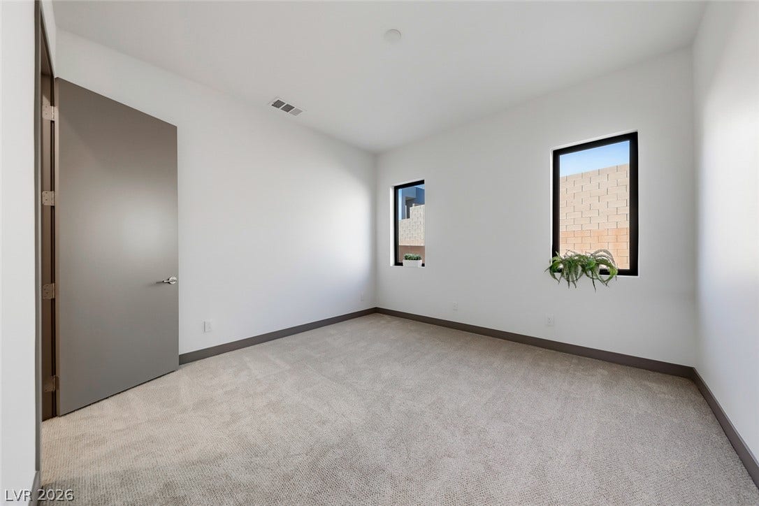 30 Sand Star Lane, Henderson, NV 89011 Crisp walls and plush carpeting define this versatile secondary bedroom space.