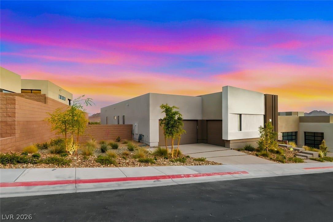 30 Sand Star Lane, Henderson, NV 89011 Clean architectural lines define this modern single-level residence nestled against a vibrant desert sunset.