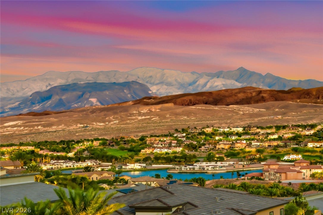 30 Sand Star Lane, Henderson, NV 89011 Dramatic mountain vistas rise above a serene neighborhood lake at twilight.
