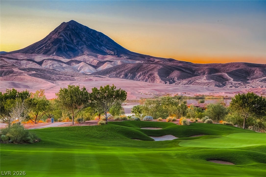 30 Sand Star Lane, Henderson, NV 89011 Dramatic mountain vistas rise above manicured fairways under a warm sunset sky.