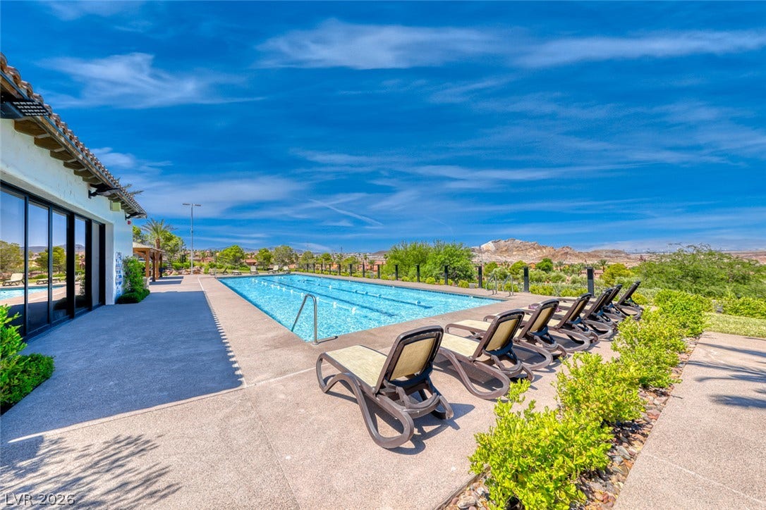 30 Sand Star Lane, Henderson, NV 89011 A sparkling outdoor pool overlooks mountain vistas under a clear blue sky.