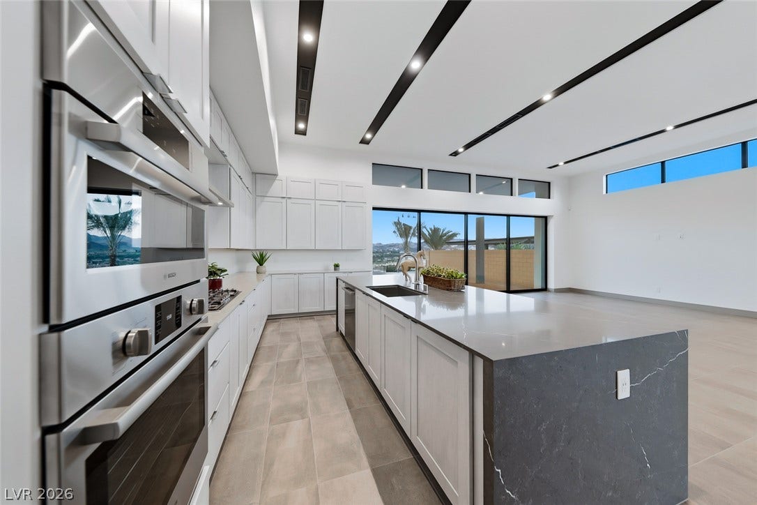 30 Sand Star Lane, Henderson, NV 89011 Gleaming stone countertops and modern built-in appliances anchor this spacious, light-filled culinary space.