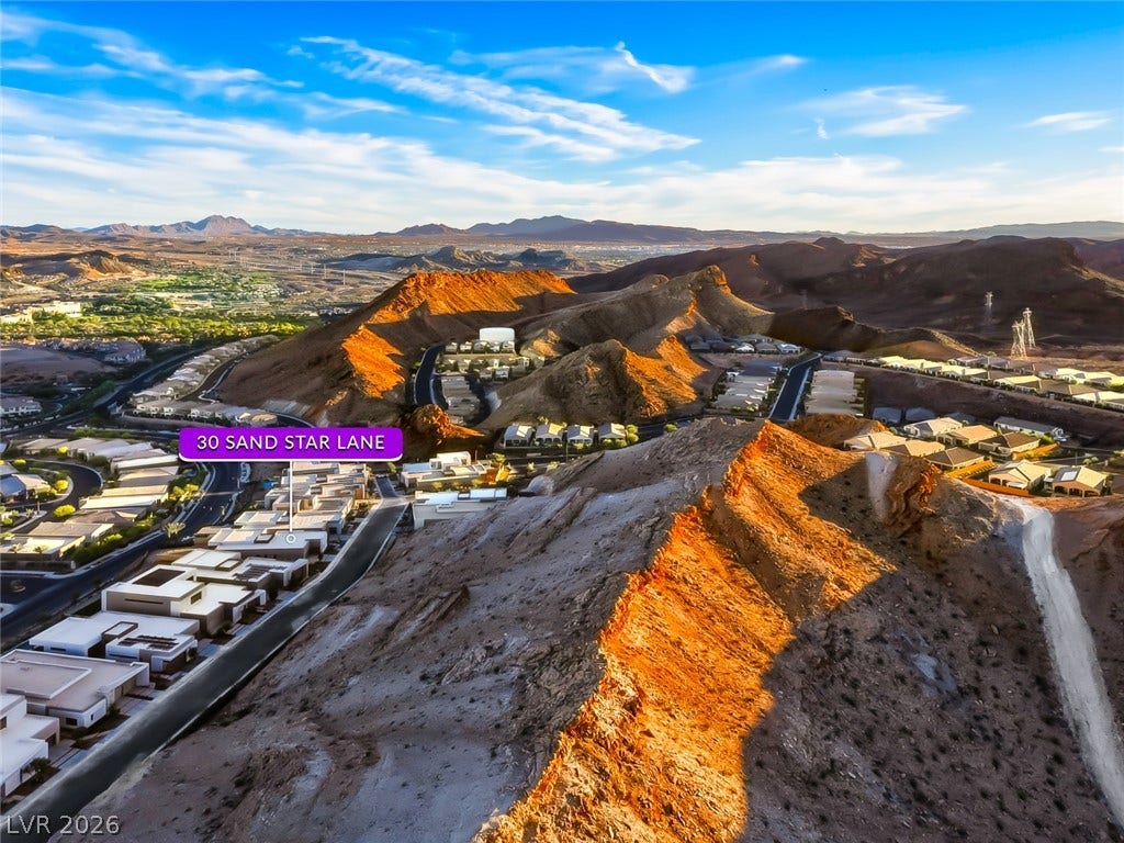 30 Sand Star Lane, Henderson, NV 89011 Dramatic desert peaks surround this quiet neighborhood under vast blue skies.