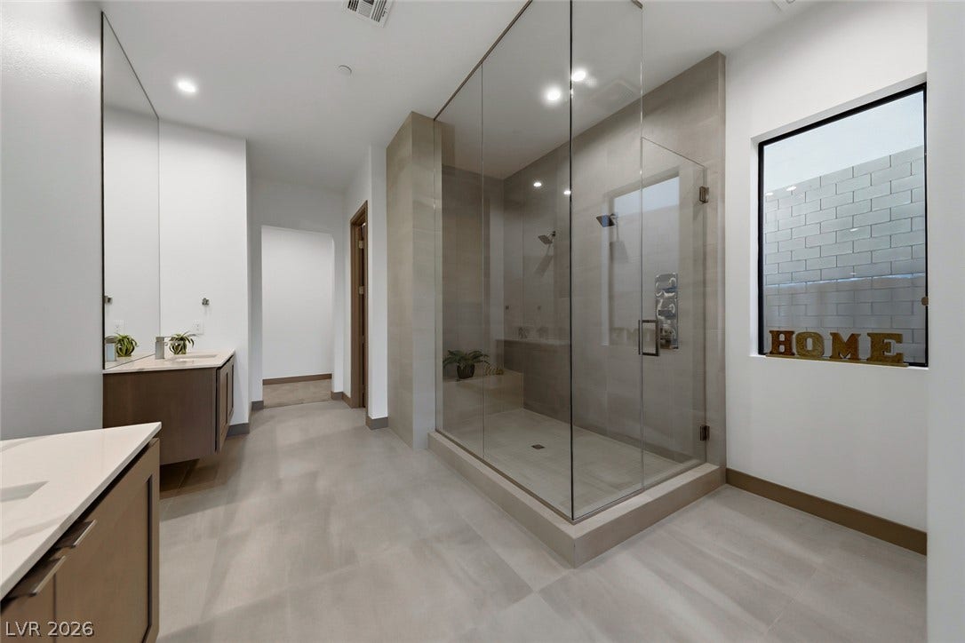 30 Sand Star Lane, Henderson, NV 89011 A spacious walk-in shower anchors this modern bathroom with clean architectural lines.