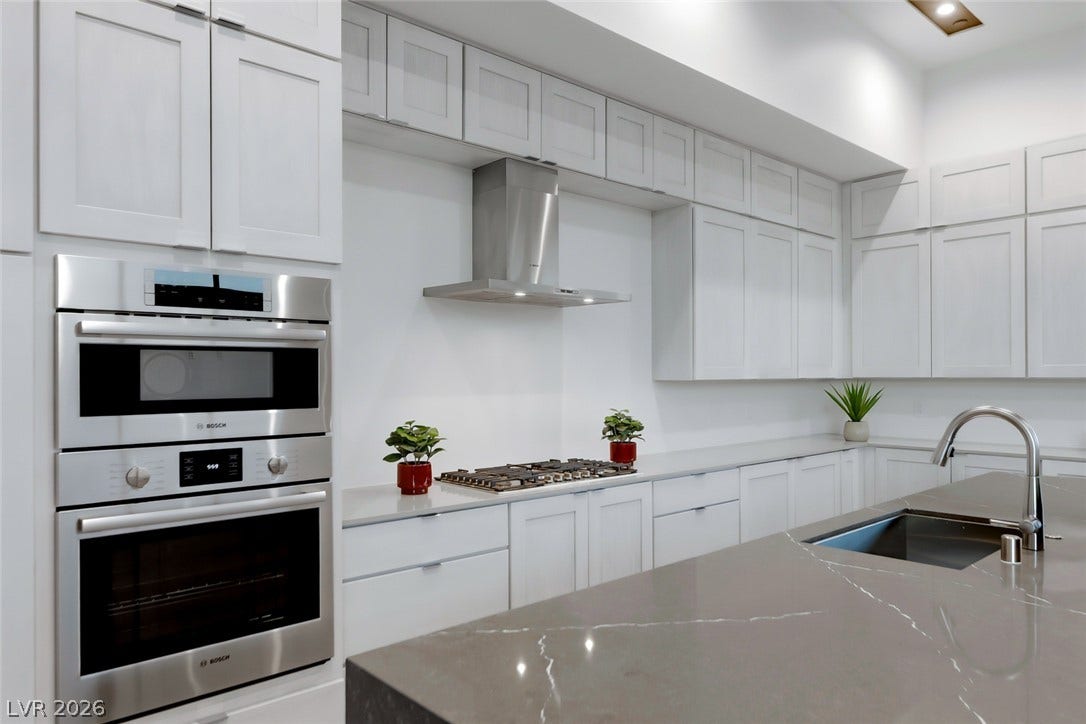 30 Sand Star Lane, Henderson, NV 89011 Premium quartz countertops anchor this modern culinary space featuring built-in appliances and extensive cabinetry.