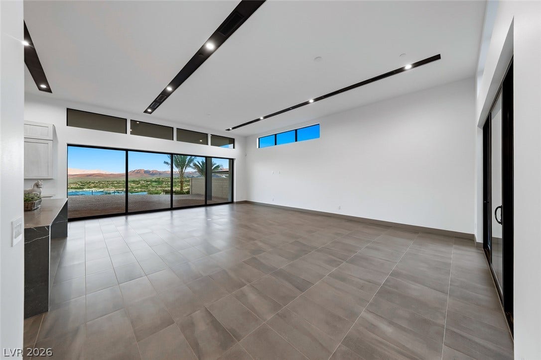 30 Sand Star Lane, Henderson, NV 89011 Clean architectural lines, sleek tile flooring, and massive sliding glass doors define this open space.