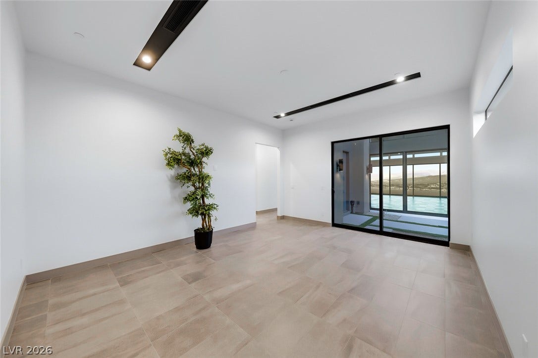 30 Sand Star Lane, Henderson, NV 89011 Clean lines and tiled flooring define this modern space with views of the pool outside.