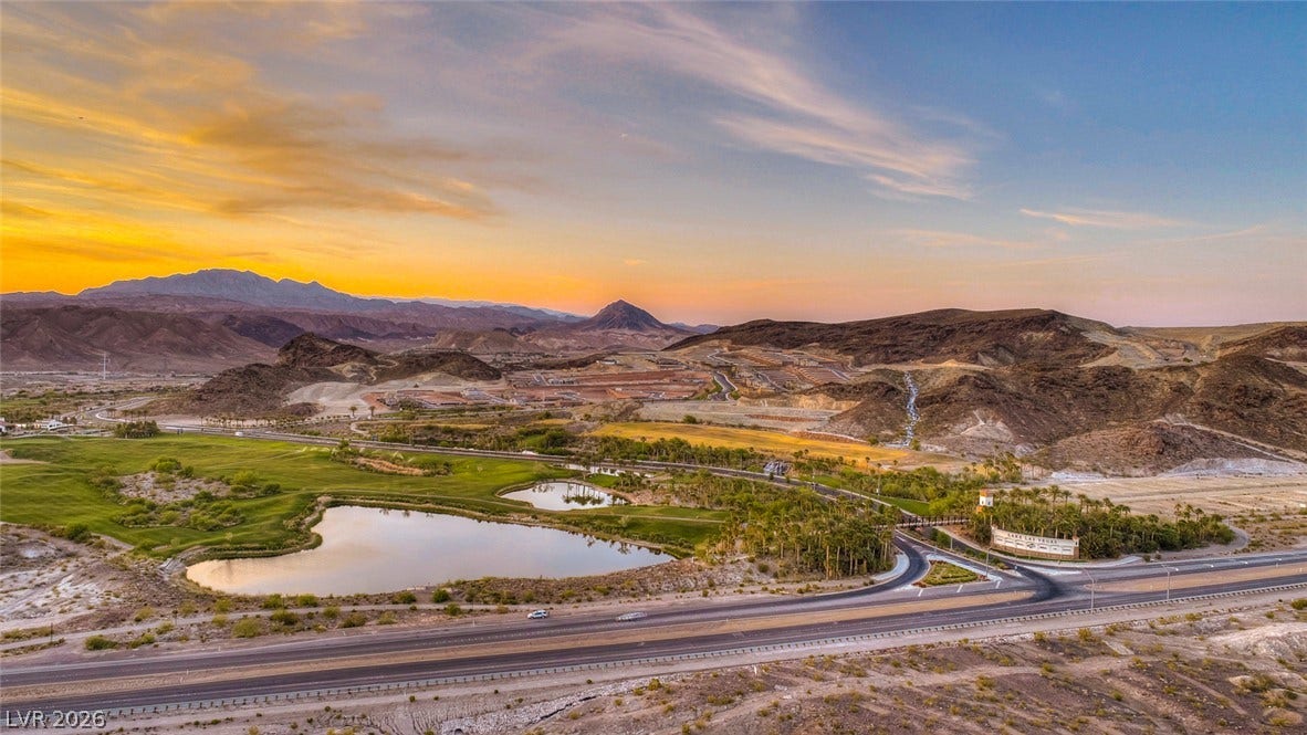 30 Sand Star Lane, Henderson, NV 89011 Epic mountain silhouettes and serene water features define this dramatic desert valley panorama.