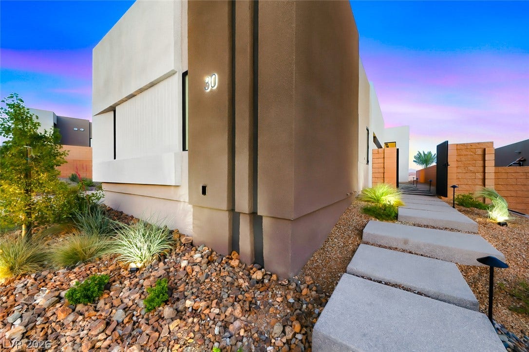 30 Sand Star Lane, Henderson, NV 89011 A floating concrete walkway leads past desert landscaping to the entrance of this modern home.