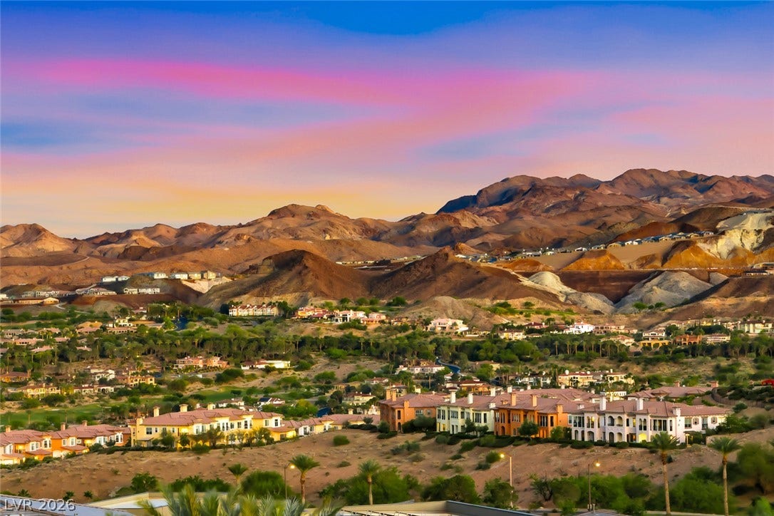 30 Sand Star Lane, Henderson, NV 89011 Dramatic mountain vistas rise above the community against a vibrant desert sunset sky.