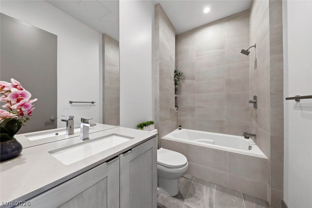 30 Sand Star Lane, Henderson, NV 89011 Sleek modern tiling and a clean vanity define this elegant bathroom space.