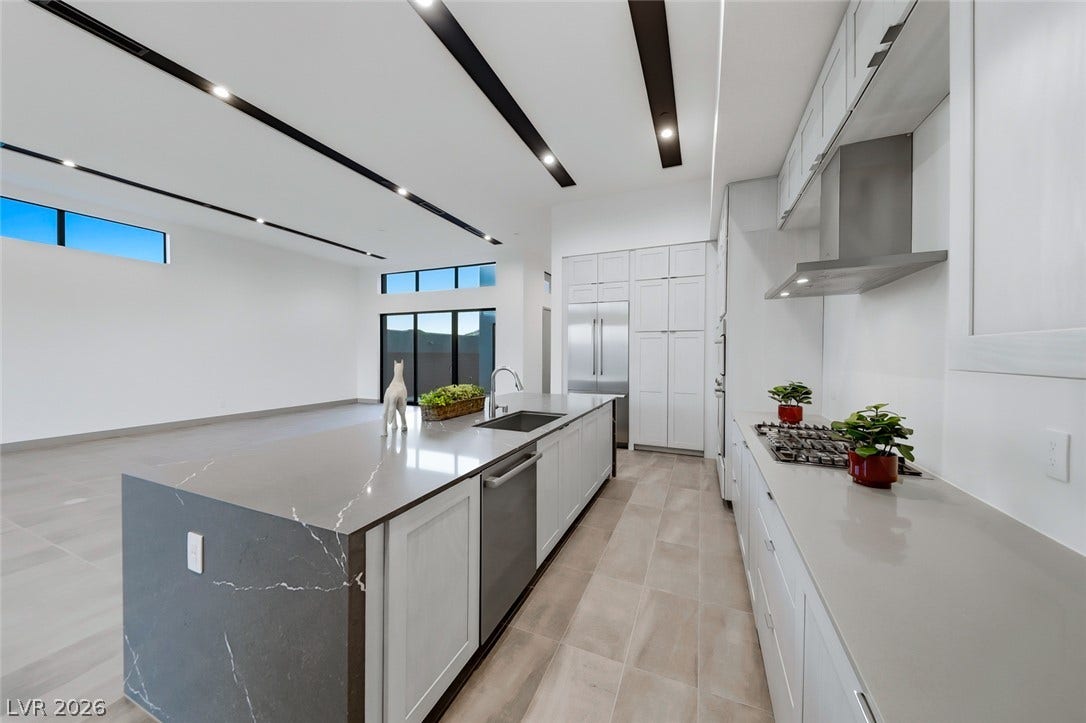 30 Sand Star Lane, Henderson, NV 89011 Clean lines and a spacious stone-waterfall island define this modern culinary space.