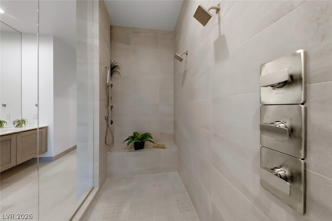 30 Sand Star Lane, Henderson, NV 89011 Floor-to-ceiling tilework and premium fixtures define this sleek walk-in shower.
