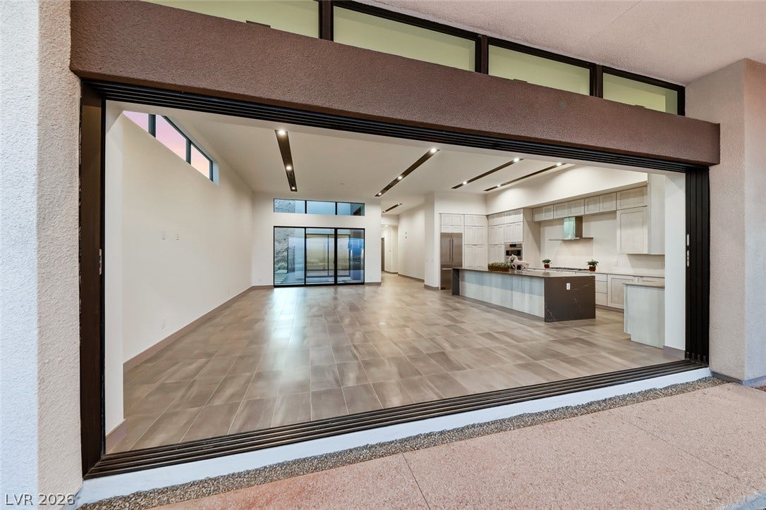 30 Sand Star Lane, Henderson, NV 89011 Massive sliding doors bridge the interior living space and outdoor patio seamlessly.