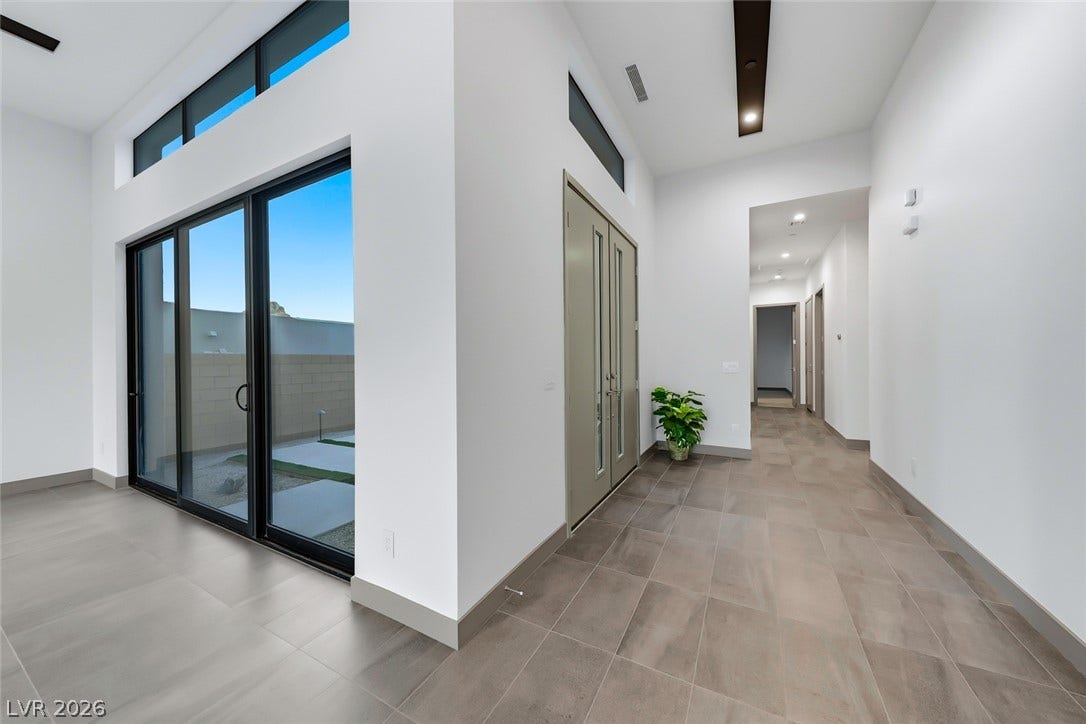 30 Sand Star Lane, Henderson, NV 89011 Towering ceilings and clean-lined tile flooring frame this airy, open entryway layout.