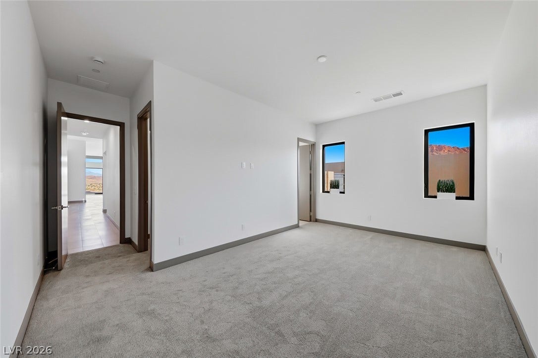 30 Sand Star Lane, Henderson, NV 89011 Recessed lighting and soft carpeting create a peaceful atmosphere in this spacious bedroom.