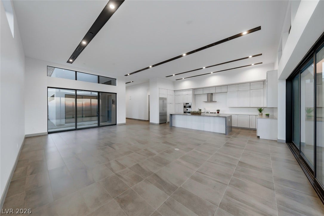 30 Sand Star Lane, Henderson, NV 89011 Clean lines and vast tile flooring define this modern, open-concept living and dining space.