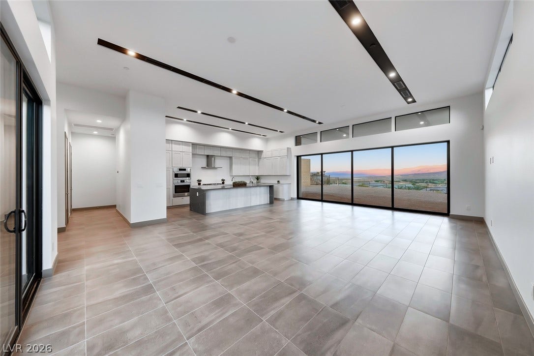 30 Sand Star Lane, Henderson, NV 89011 Massive sliding glass doors open this airy living space to long-range mountain views.