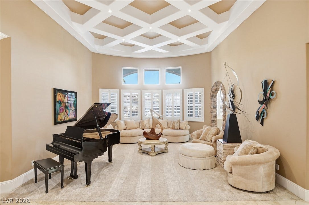 6625 W El Campo Grande Avenue, Las Vegas, NV 89130 An intricate coffered ceiling crowns this elegant living space featuring soft neutral finishes.