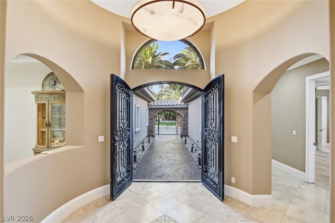 6625 W El Campo Grande Avenue, Las Vegas, NV 89130 Double iron entry doors swing open to a tiled foyer under soaring circular ceilings.