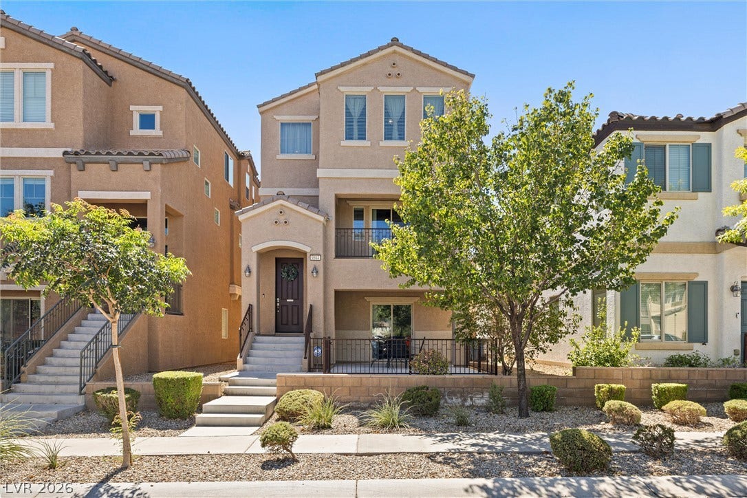 8944 Red Tapestry Court, Las Vegas, NV 89149 Multi-level modern stucco exterior showcases architectural symmetry and a welcoming gated entry porch.
