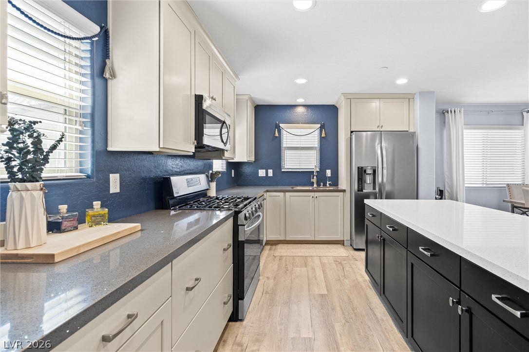 8944 Red Tapestry Court, Las Vegas, NV 89149 Gleaming quartz countertops and a spacious central island anchor this modern culinary workspace.