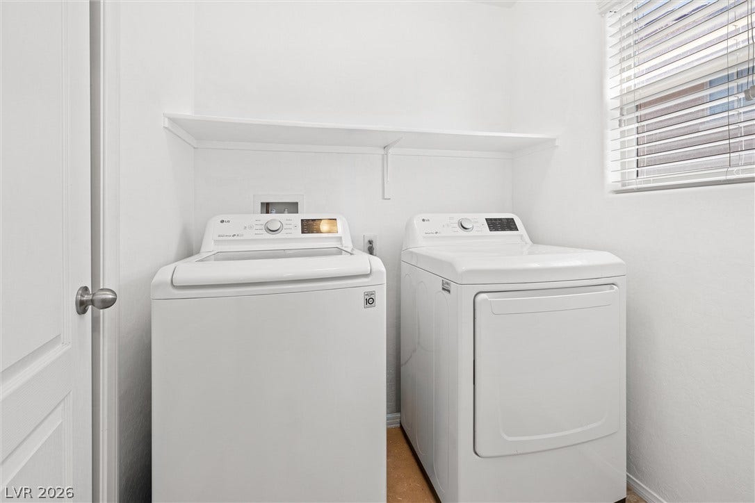 8944 Red Tapestry Court, Las Vegas, NV 89149 A functional laundry space featuring a built-in shelf and a window that provides natural light. With a walk in pantry or storage closet