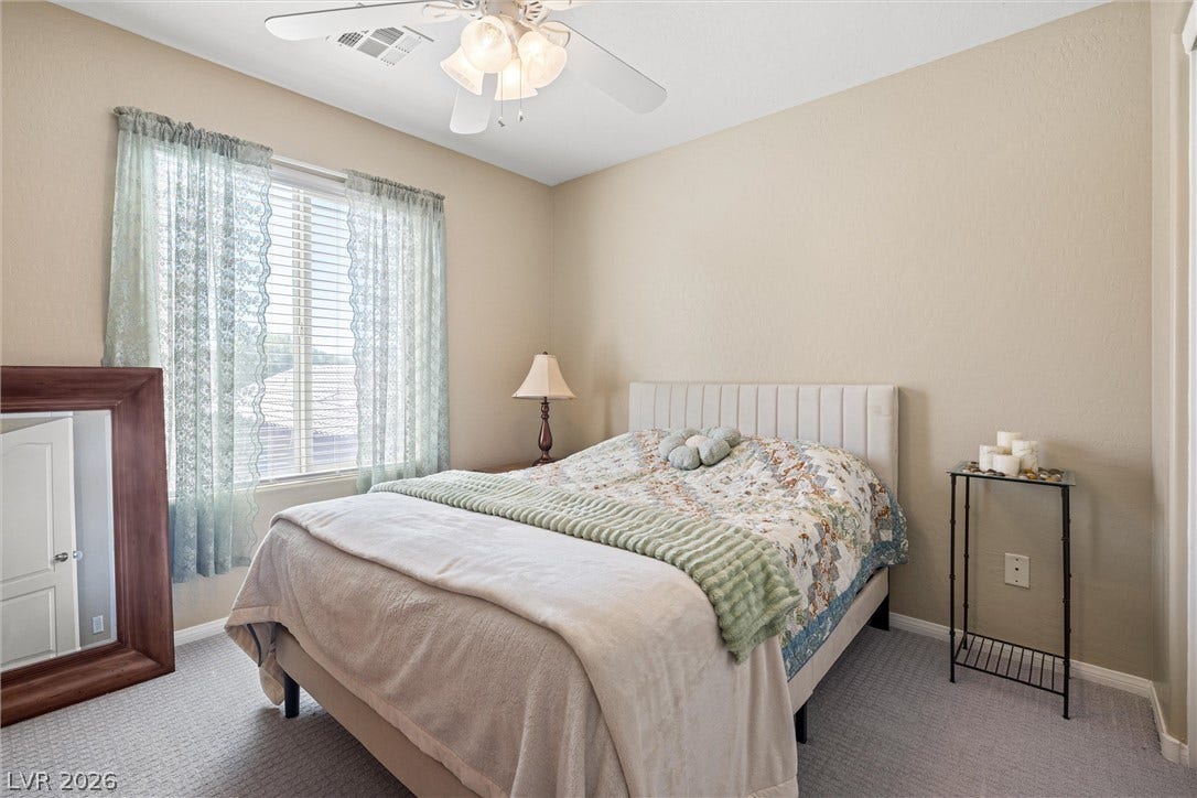 8944 Red Tapestry Court, Las Vegas, NV 89149 Soft carpeting pairs with a large multi-lite window in this cozy sleeping space.