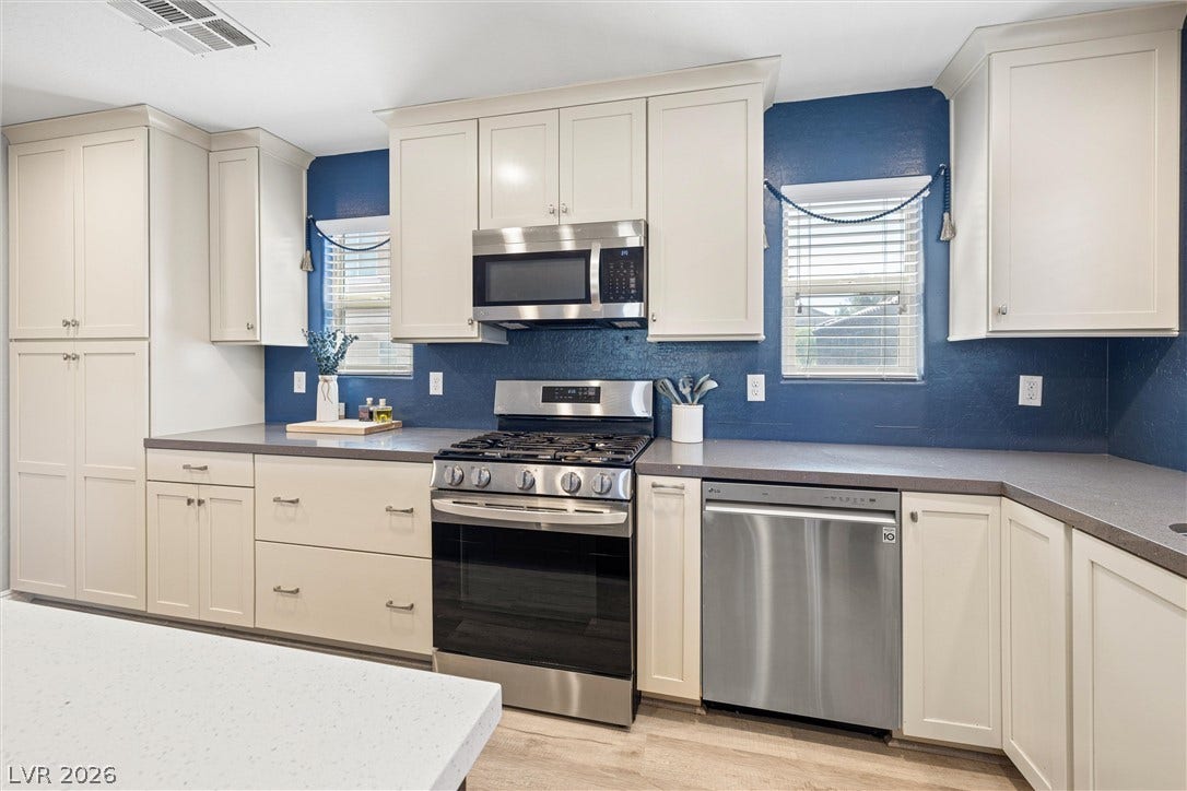 8944 Red Tapestry Court, Las Vegas, NV 89149 Streamlined cabinetry and modern appliances create a highly functional workspace.