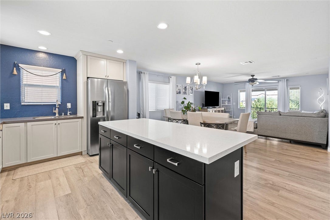 8944 Red Tapestry Court, Las Vegas, NV 89149 An expansive open floorplan connects the central kitchen island to the bright living areas.