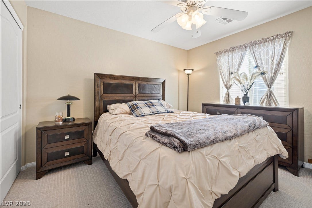 8944 Red Tapestry Court, Las Vegas, NV 89149 Plush carpeting and a multi-paned window define this serene, comfortable bedroom space.