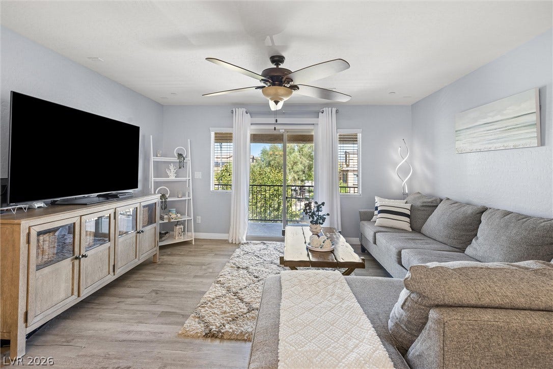 8944 Red Tapestry Court, Las Vegas, NV 89149 Sliding doors open to a private balcony from this inviting living area with Luxury Vinyl flooring.
