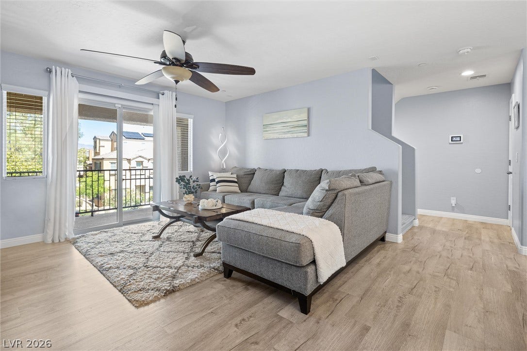 8944 Red Tapestry Court, Las Vegas, NV 89149 Sliding glass doors open to a private balcony from this modern living space.