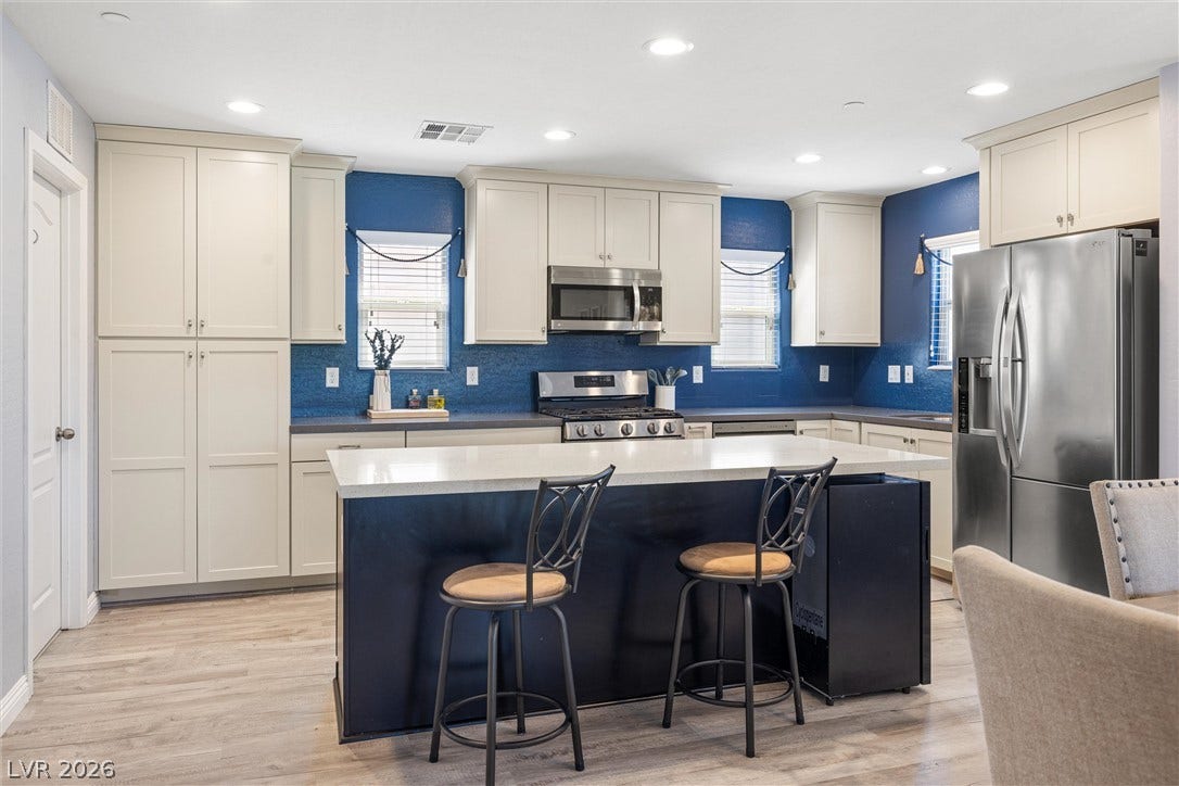 8944 Red Tapestry Court, Las Vegas, NV 89149 An inviting kitchen features a generous center island with smooth quartz counters and ample cabinetry.